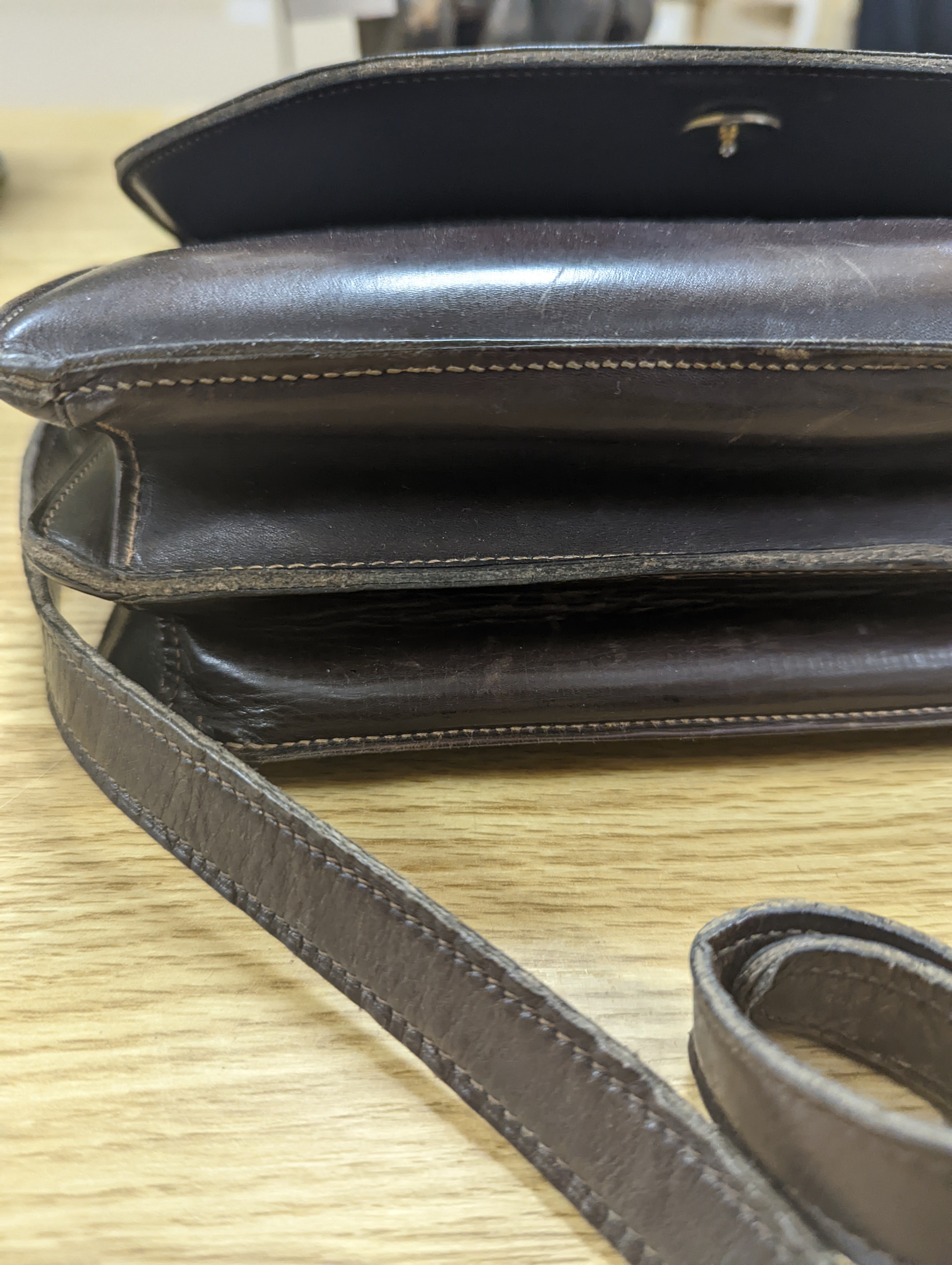 A vintage brown leather handbag stamped 